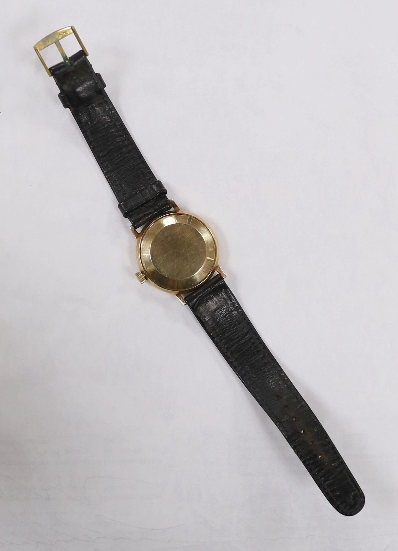 A gentleman's yellow metal (Swiss 9ct mark) J.W. Benson automatic day(in French & English)/date wrist watch, on associated strap, case diameter 34mm, gross weight 36.8 grams.